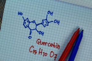 Quercetin chemical structure formula C15H10O7 drawn on graph paper with markers