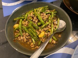 Bowl of Crohn’s-friendly Szechuan pork stir fry with green beans, garlic, and ground pork in sauce