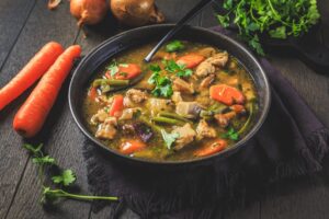 Crohn’s appropriate beef soup with chuck roast, carrots, and vegetables in a dark bowl.