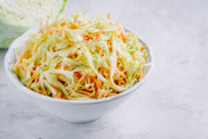 Paleo sweet and sour coleslaw made with cabbage, carrots, honey, and vinegar.