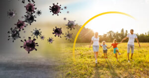 Family walking outdoors protected by an immunity shield against viruses — concept of vitamin A and immune system support.