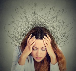 Woman feeling anxious and overwhelmed, symbolizing the mental strain linked to anxiety and stress.
