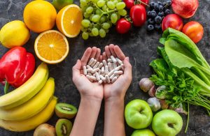 Vitamins and supplements with fresh fruits and vegetables for balanced nutrition